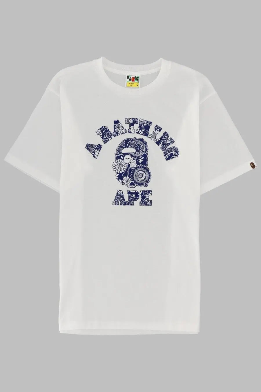 A bathing ape men’s white t-shirt with navy blue floral-patterned logo featuring the iconic ape head design