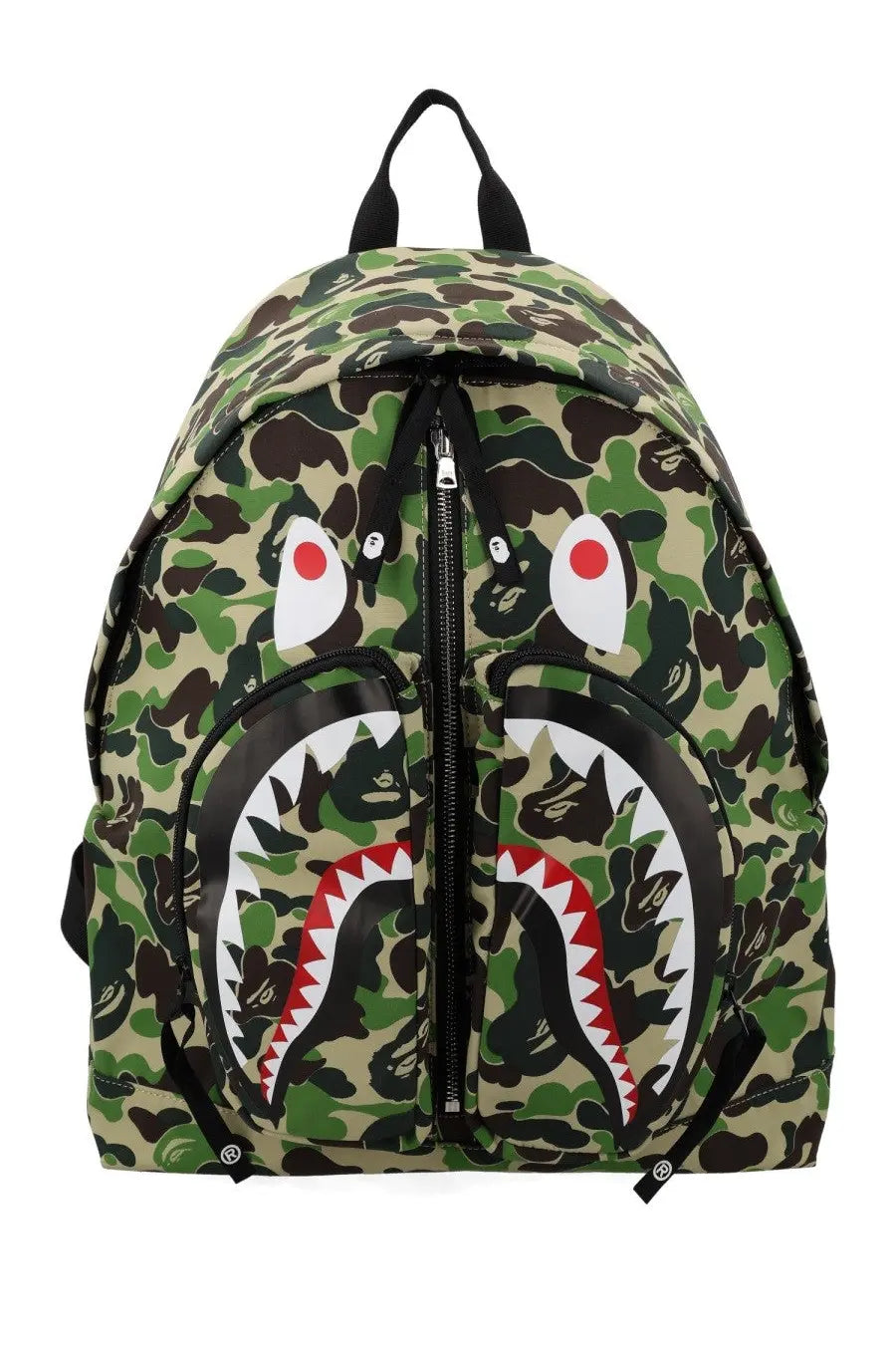A bathing ape men’s shark green backpack with camouflage pattern and bold stylized shark face with red white teeth accents
