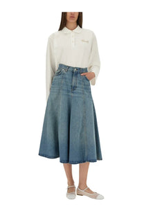 A high waisted medium blue denim skirt with a flared silhouette and raw hem for women by Baum und Pferdgarten
