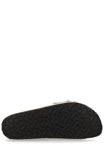 Black rubber sole with wavy tread pattern on the back side of birkenstock unisex sandal madrid big buckle pink