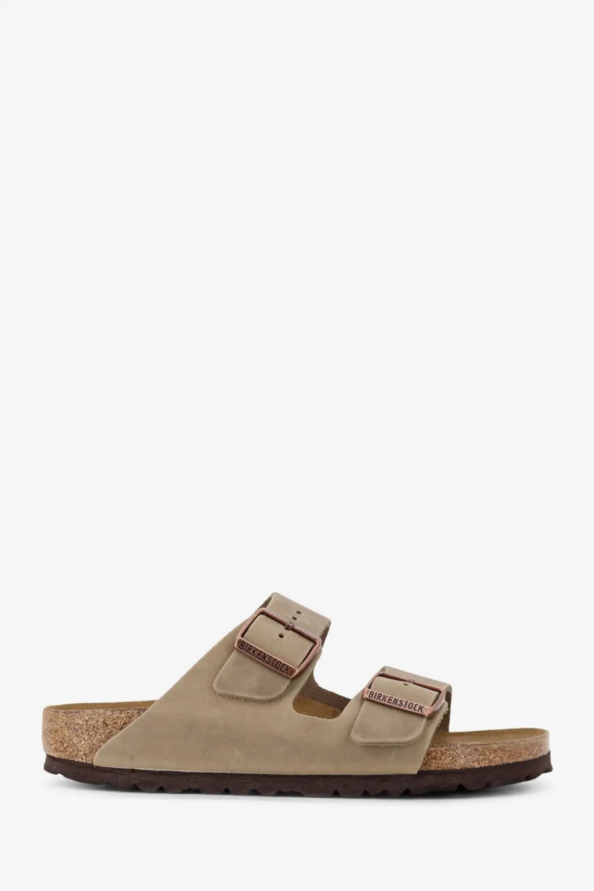 Beige suede birkenstock women’s arizona sandals with two adjustable straps and cork footbed in brown