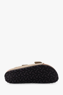 Beige suede birkenstock women’s arizona clog with black rubber sole featuring distinctive wavy pattern