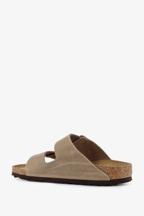 Beige birkenstock women’s arizona suede sandals with cork footbed and two wide straps