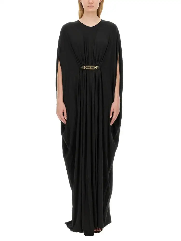 Black pleated cape dress with gold-toned chain belt.