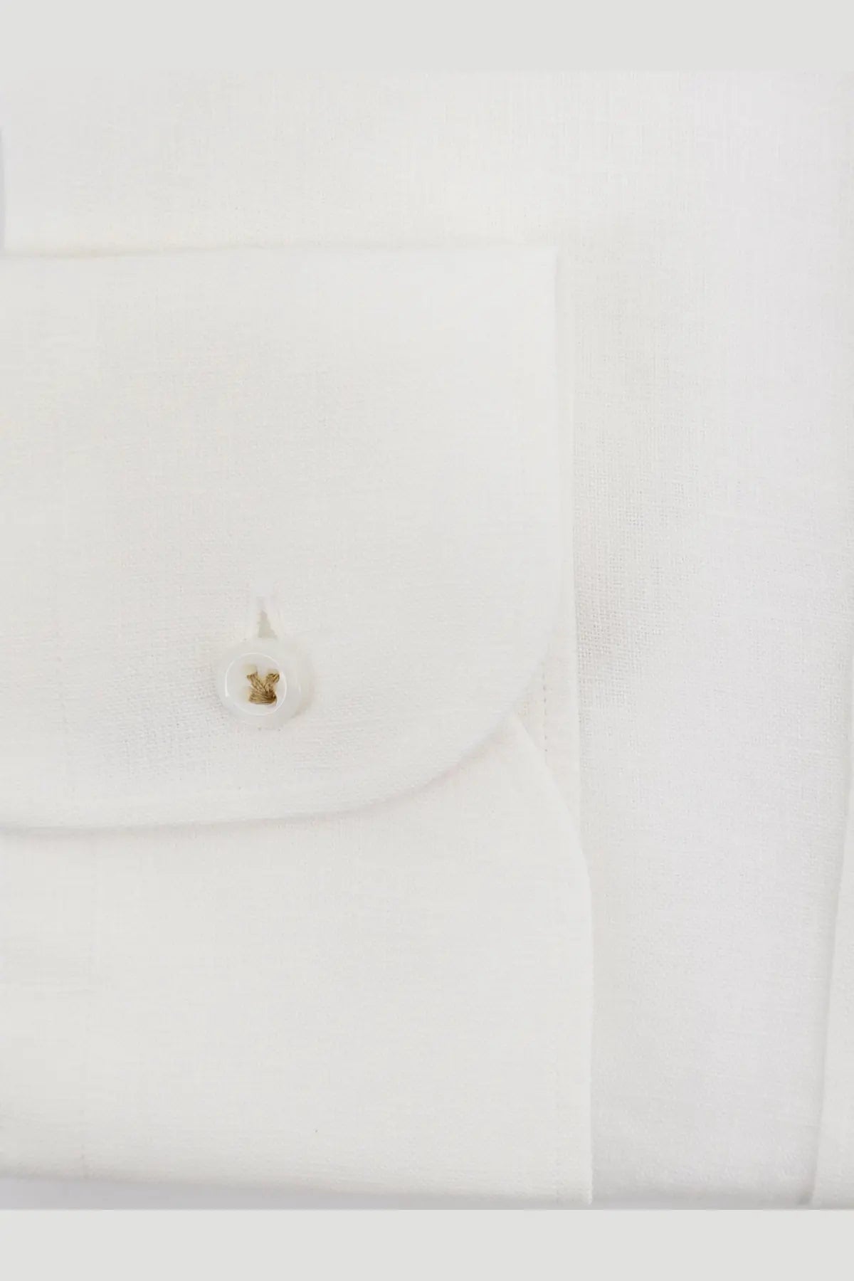 White buttonhole with gold circular stud embossed design on boss men’s white linen shirt close-up detail