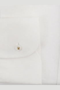 White buttonhole with gold circular stud embossed design on boss men’s white linen shirt close-up detail