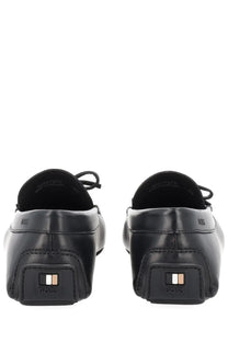 Black leather loafers with a sleek minimalist design and boss logo embossed on the heel shown from the back side