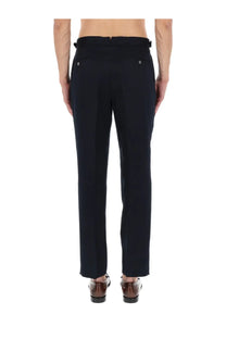 Black tailored men’s trousers by BOSS with a sleek straight-leg cut and subtle back pleats shown from the back side