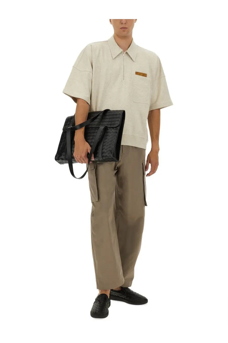 Black crocodile-embossed leather satchel bag paired with Bottega Veneta men’s beige cargo pants