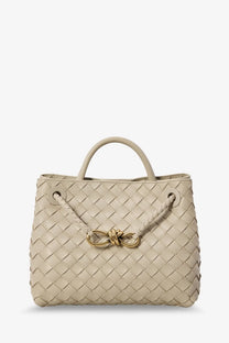 Beige woven leather tote bag with gold-tone bow clasp by bottega veneta for women