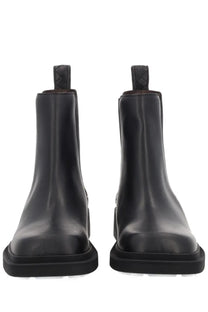 Bottega Veneta women’s black leather Chelsea boots with chunky sole and braided pull tabs front view