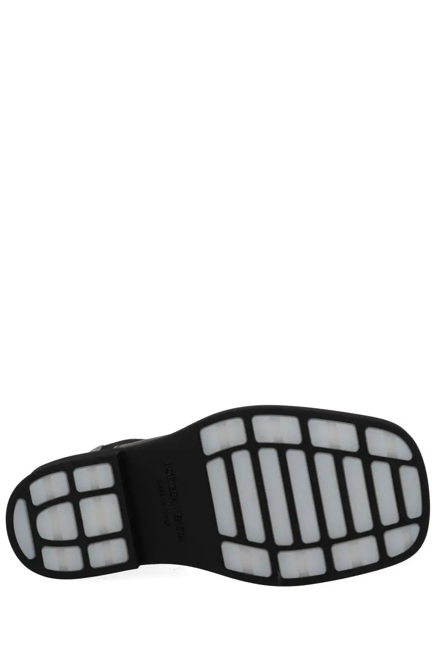 Black rubber sole with white traction blocks on bottega veneta women’s boot chelsea ben black minimalist design