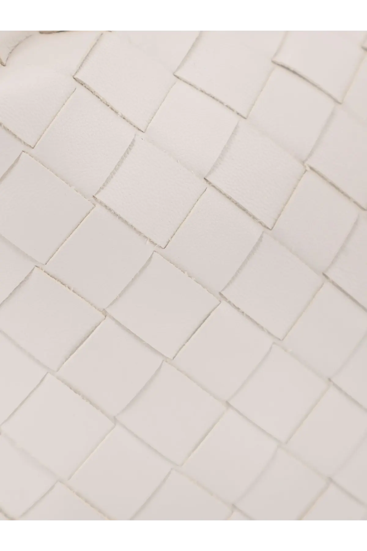 White woven leather strap with a clean geometric pattern on bottega veneta women’s mini hop leather crossbody bag