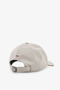 Beige Brunello Cucinelli men’s baseball hat with subtle red stitch detail and adjustable strap shown from the back