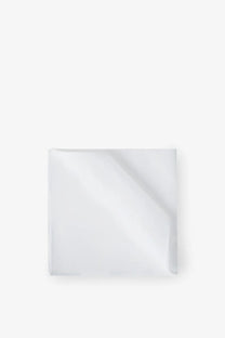 A crisp white cotton pocket square by brunello cucinelli neatly folded with subtle sheen and clean edges