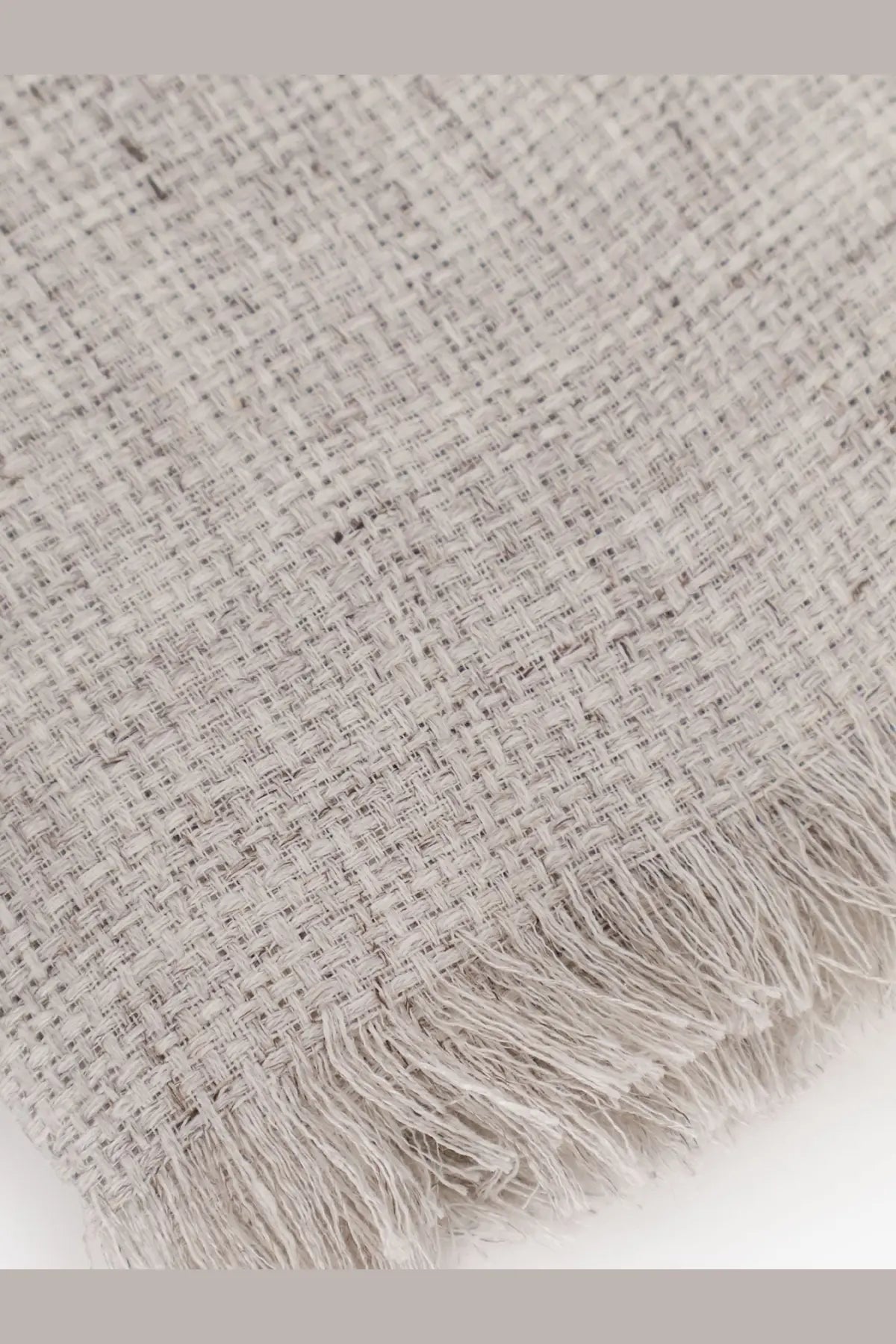 A soft light gray woven throw blanket with textured weave and natural fiber fringe for brunello cucinelli men’s linen scarf gray