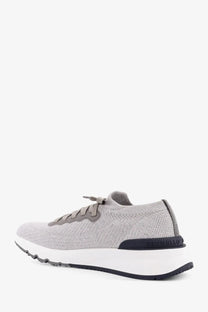 Back view of brunello cucinelli men’s low top silver cotton knit and leather sneaker with white and black sole