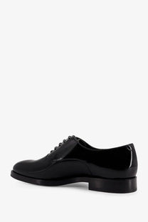 Brunello Cucinelli men’s black patent leather derby shoe with polished finish and classic lace-up design