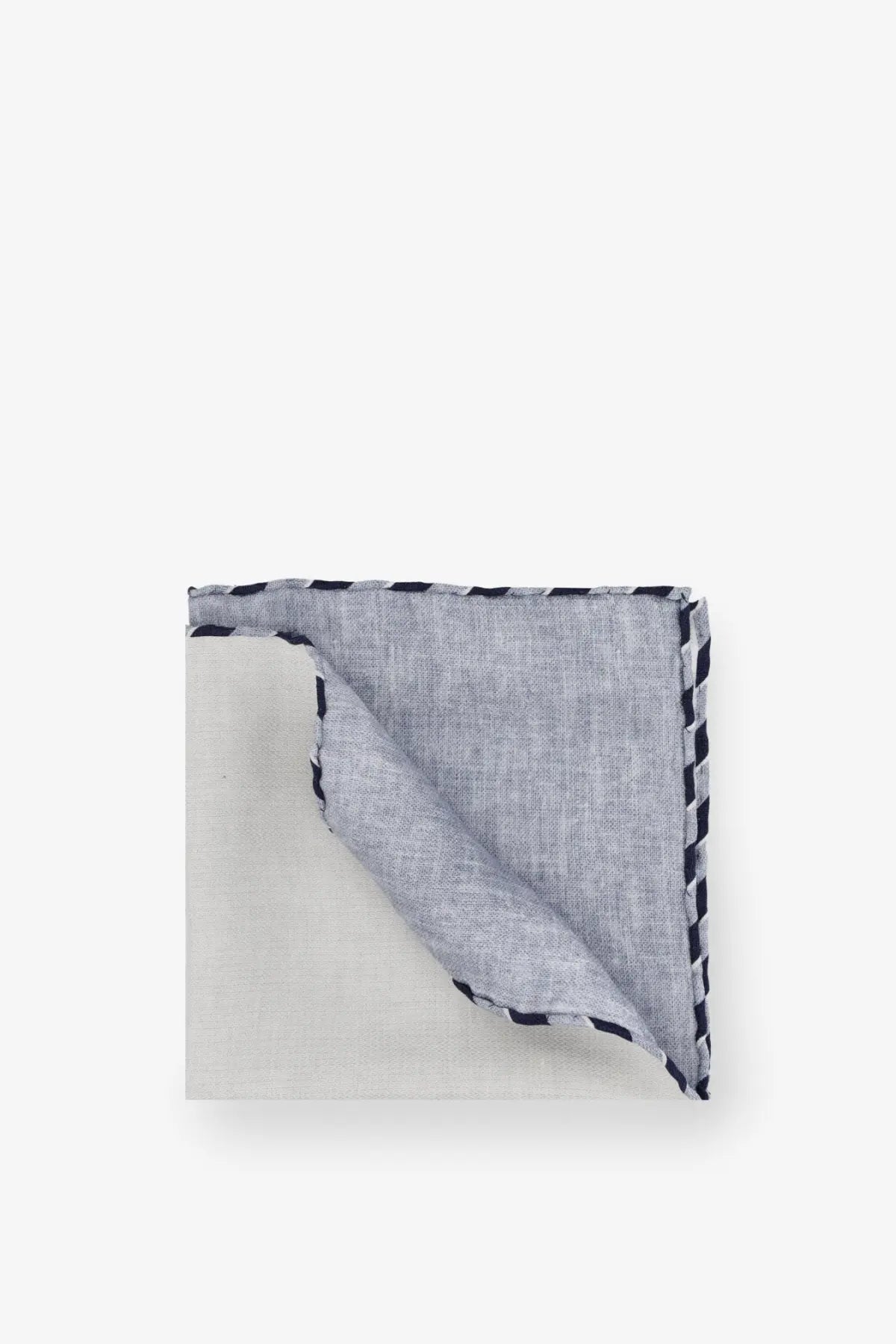 A neatly folded brunello cucinelli men’s silk pocket panama in light gray linen with black and white zigzag stitched border