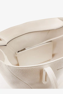Brunello Cucinelli women’s cream-colored pebbled leather tote bag with minimalist design and subtle brand embossing