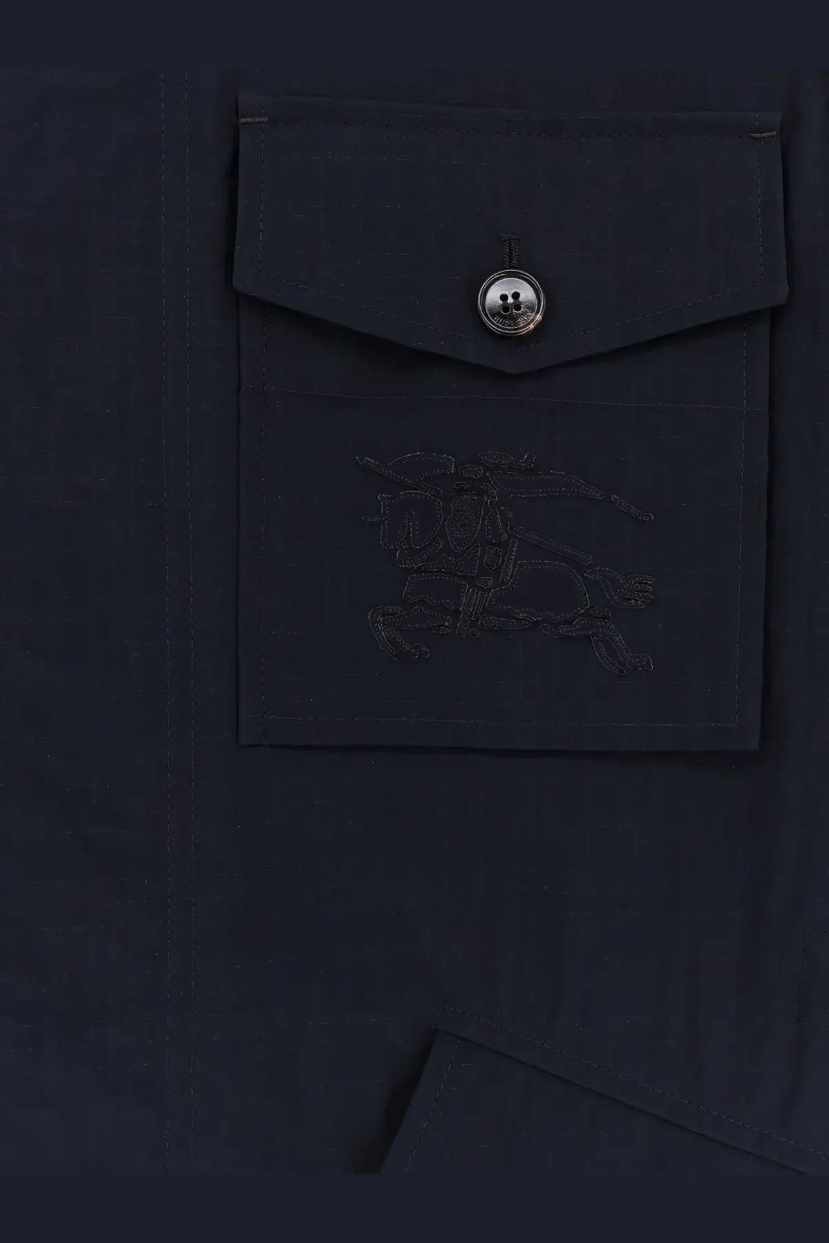 Dark navy burberry men’s bradmore nylon jacket pocket with silver button and subtle embroidered logo