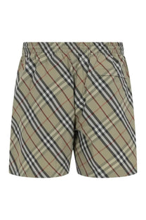 Burberry men’s check swimsuit green beige and black diagonal striped swim trunks with red accent and elastic waistband