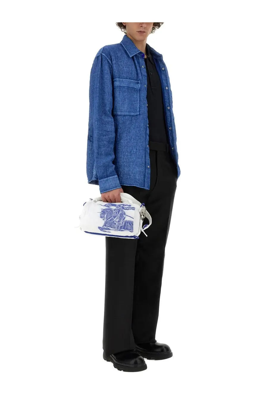 White handbag with blue embroidered design and silver hardware paired with burberry men’s blue linen shirt