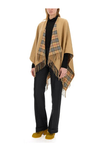 Beige woolen burberry women’s reversible check wool cape with classic check pattern and fringed edges displayed front side