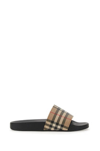 Burberry women’s black rubber slide sandal with beige black and red checkered fabric strap featuring iconic Burberry pattern