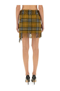 Burberry women’s wool and cashmere olive and black plaid mini skirt with fringe detailing at the hem