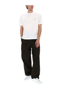 White cotton t-shirt with small subtle logo on left chest paired with c.p. company men’s pantalone cargo con patch green