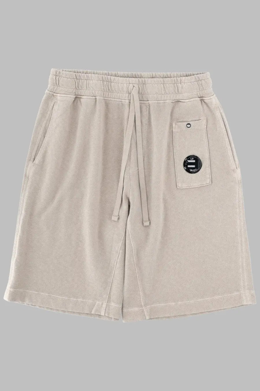 C.P. Company men’s beige cotton shorts with drawstring waistband and black circular patch on front pocket