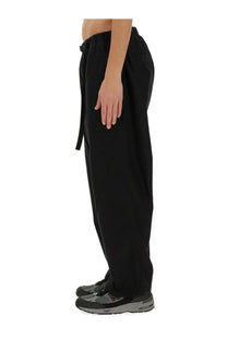 Carhartt Wip men’s black drawstring belt pants with relaxed tapered fit and subtle side pockets