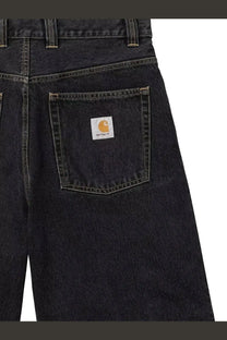 Back side of carhartt wip men’s brandon bermuda shorts in black denim with classic carhartt logo patch on pocket