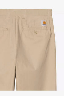 Beige carhartt wip men’s calder cotton blend trousers iroko shown from the back with white label and orange logo on pocket