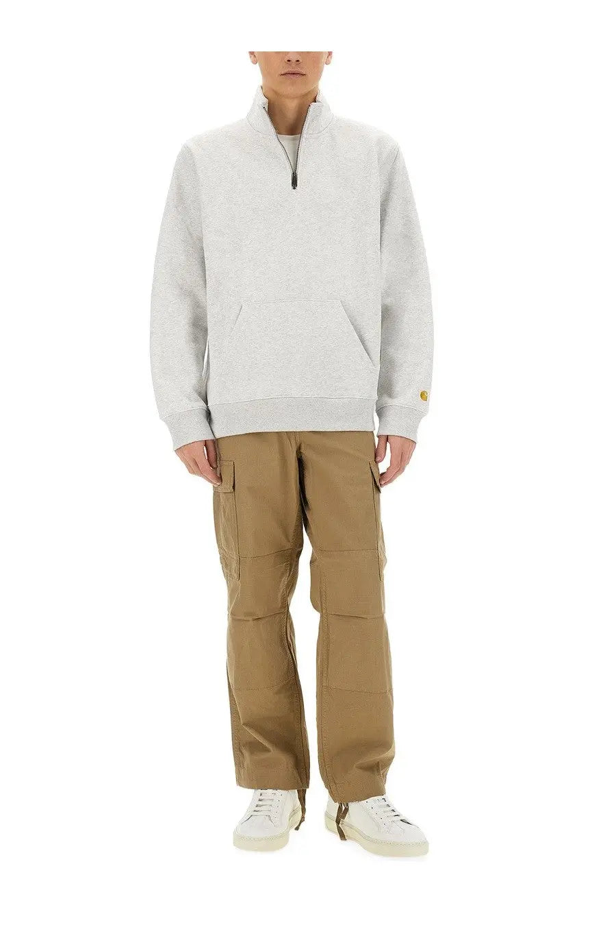 Light gray carhartt half zip sweatshirt with ribbed cuffs and hem paired with beige cargo pants for men