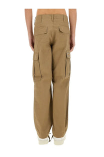 Carhartt wip men’s beige cargo pants with multiple pockets and a visible brand patch on the thigh