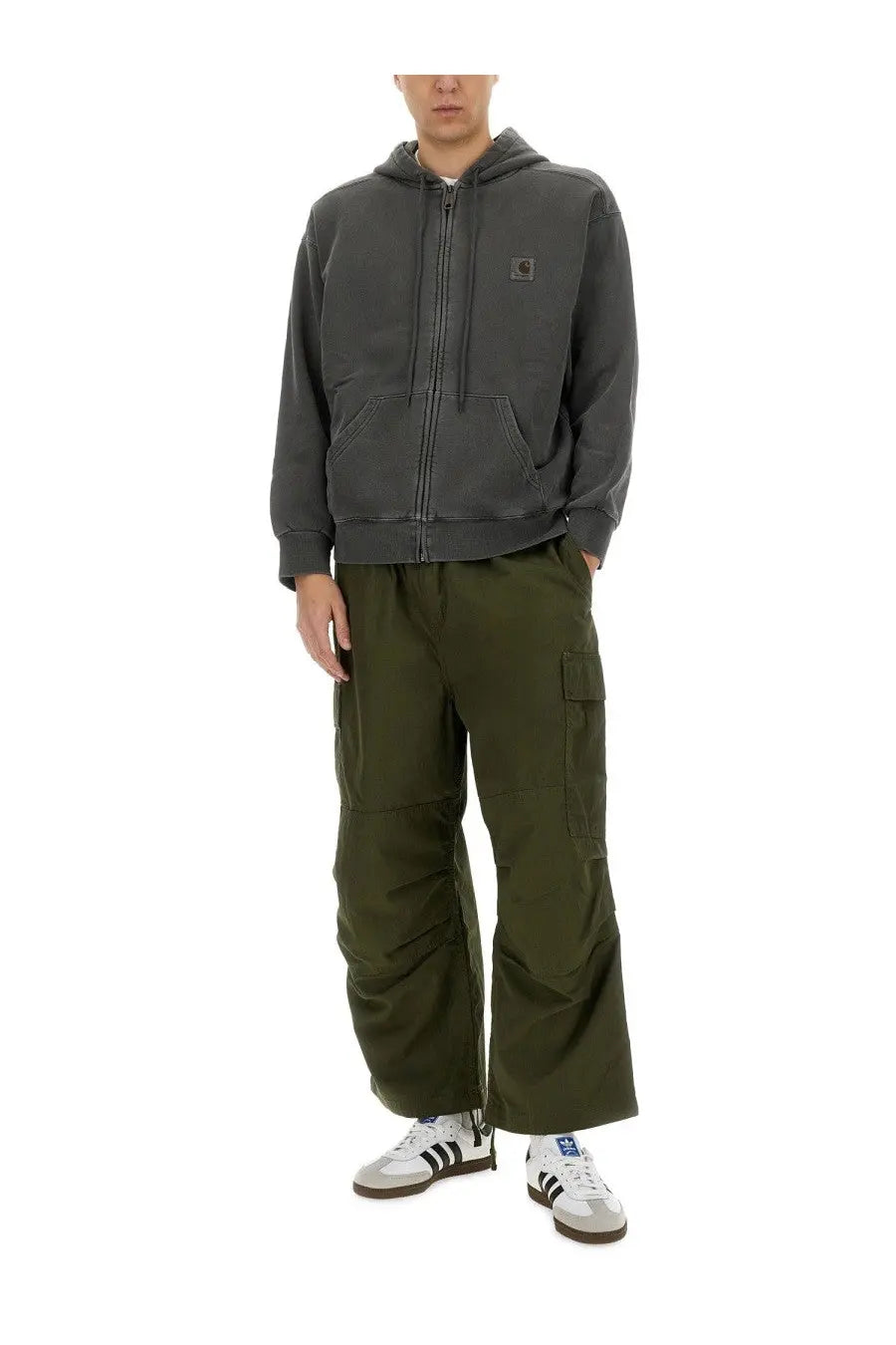 Dark gray Carhartt hoodie with front zipper hood and chest logo paired with green men’s cargo pants