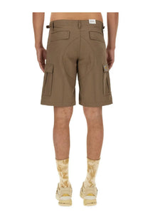 Tan carhartt wip men’s cotton bermuda shorts with multiple pockets and a brand patch on the thigh