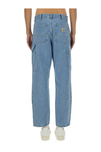 Back view of light-wash denim carhartt wip men’s double knee cargo pants with logo patch on back right pocket