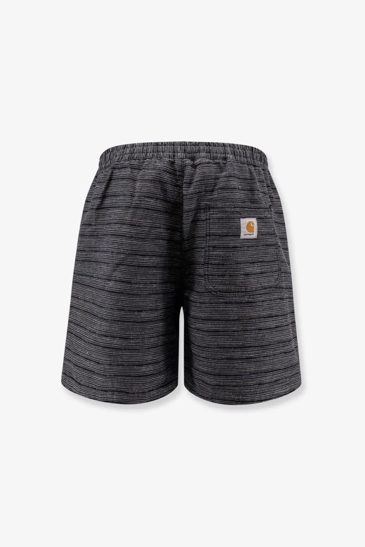 Back view of black and gray striped carhartt wip men’s gellar relaxed fit shorts with woven texture and orange logo patch