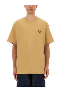 A mustard yellow oversized cotton t shirt with a small brown heart shaped patch by carhartt wip men beige