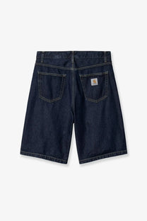 Back side of dark indigo carhartt wip men’s landon denim bermuda shorts with classic logo patch on pocket