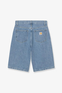 Back view of light-wash blue denim carhartt wip men’s langdon bermuda shorts with logo patch on right pocket