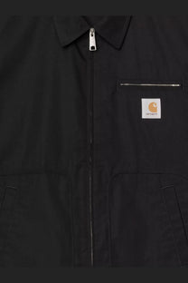 Carhartt Wip men’s postal cotton blend jacket in black with silver zipper and orange logo patch on the front