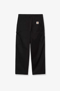 Back side of black carhartt wip men’s postal single knee cotton blend work trousers with durable design and subtle brand patch
