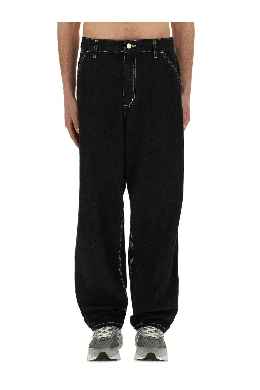 Carhartt WIP men’s black single knee wide-leg denim pants with white stitching and yellow button detail