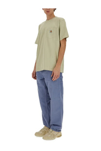 Light green carhartt t-shirt with chest pocket and small logo patch paired with blue carhartt wip men’s single knee pants