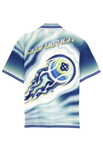 A vibrant blue and white Casablanca men’s polo shirt featuring a flaming tennis ball graphic and short sleeves