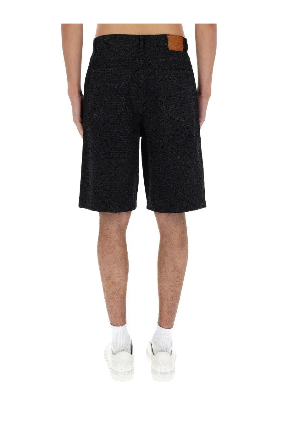 Black denim Casablanca men’s laser monogram shorts showing the back with a brown leather patch at the waistband